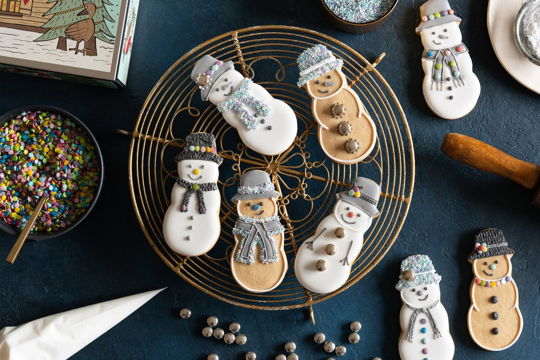 DIY snowman biscuit decorating kit with icing and sprinkles, perfect for Christmas fun and personalized gifts from Biscuiteers.