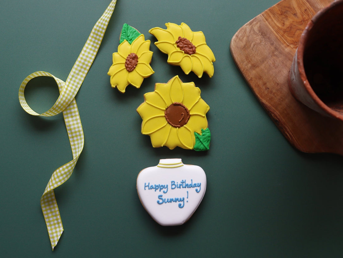 Hand-iced sunflower biscuits by Biscuiteers, perfect for personalised gifts and thoughtful colleague celebrations.