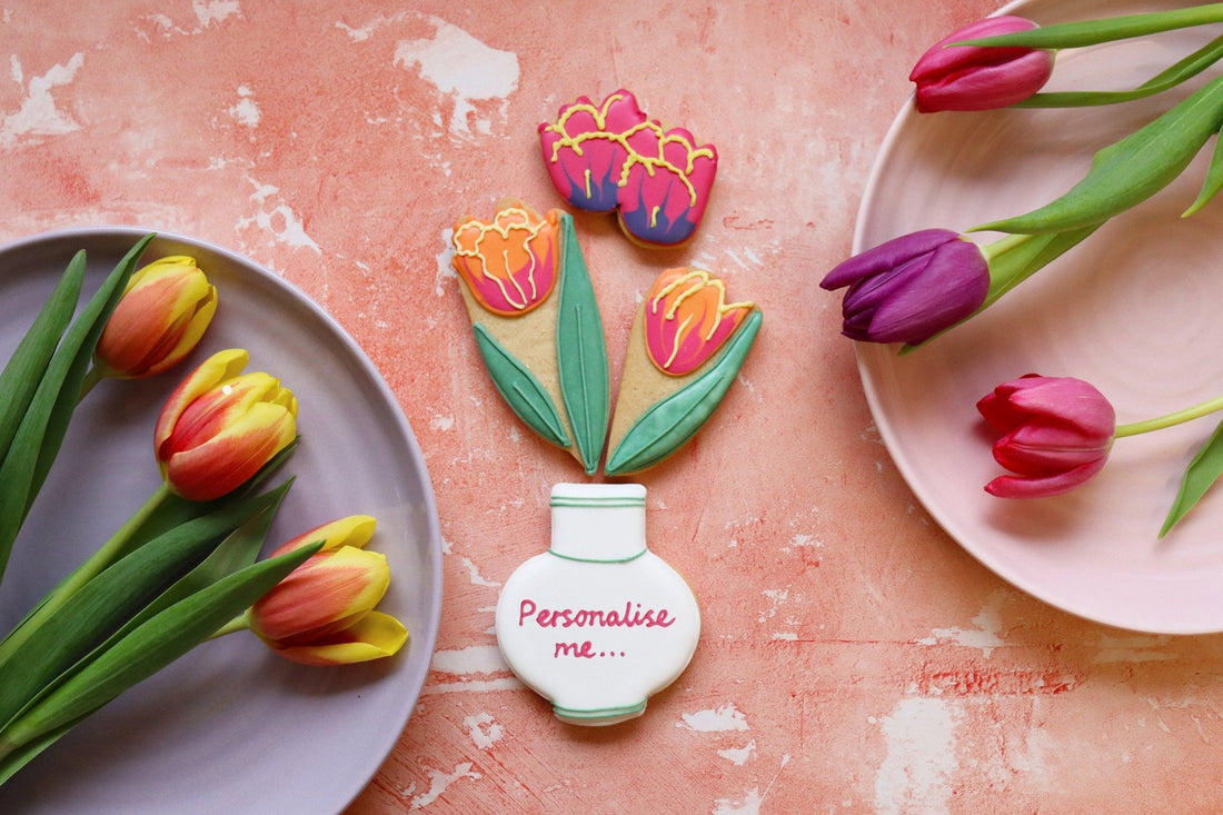 Tulips in a vase with Biscuiteers' personalised gifts, perfect for spring occasions, showcasing hand-iced biscuit artistry.