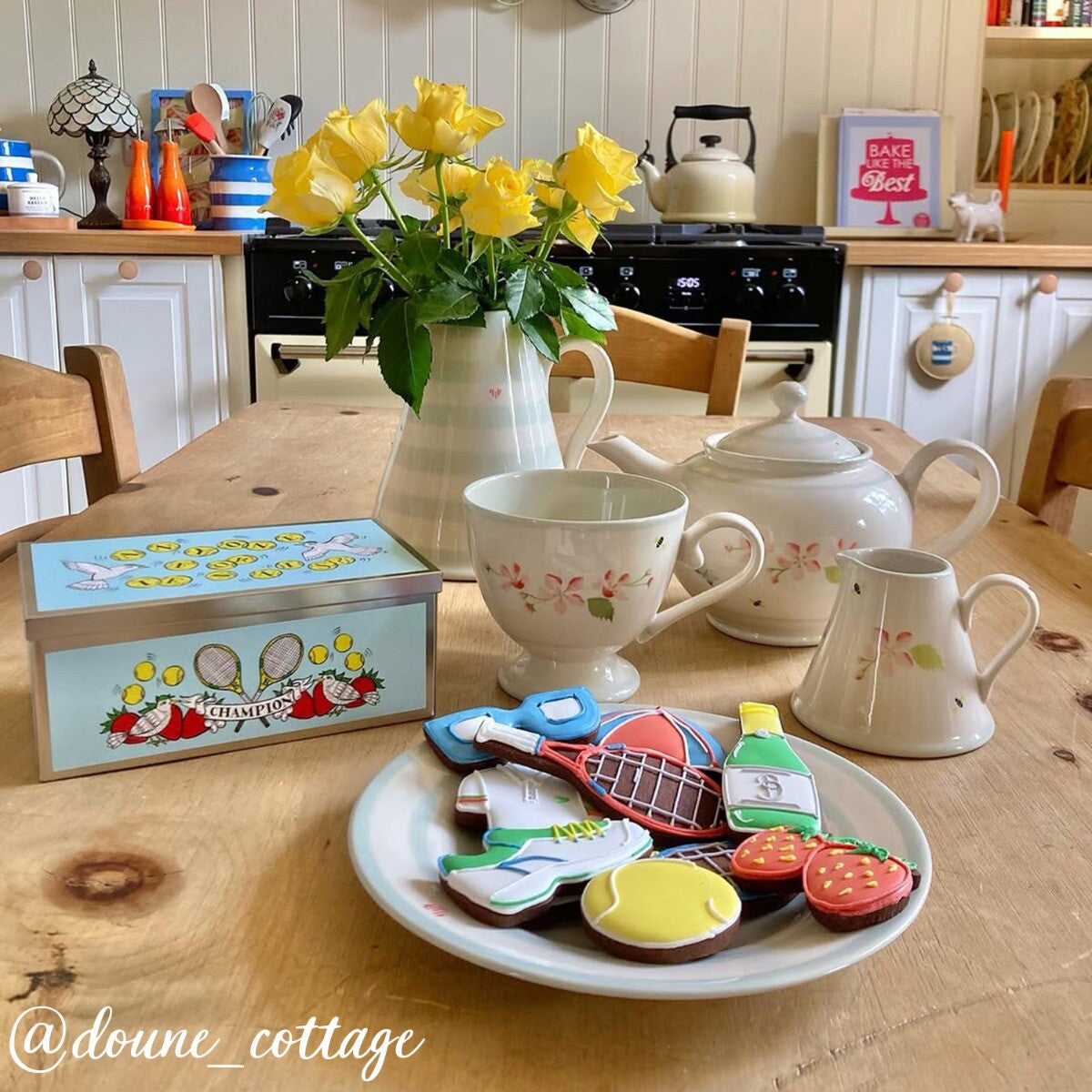 Hand-iced tennis-themed biscuits in a decorative tin, perfect personalised gift or birthday treat for tennis enthusiasts.