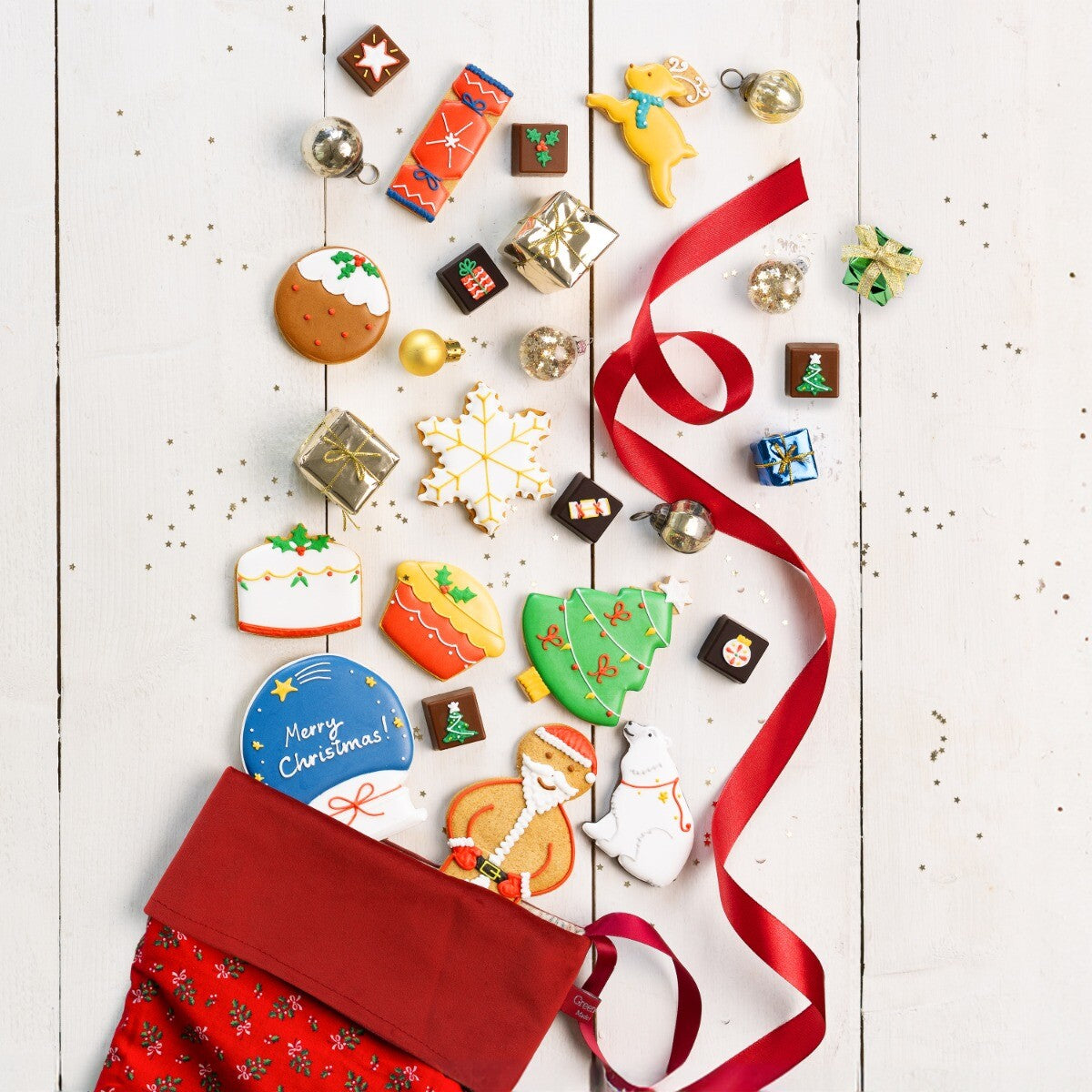 Hand-iced Christmas stocking filler biscuits, perfect personalised gift from Biscuiteers' Christmas Shop.