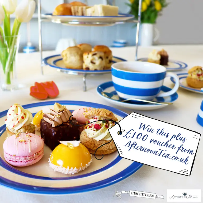 Biscuiteers afternoon tea displayed on table with tag over image reading Win this plus 100 voucher from Afternoonteacouk